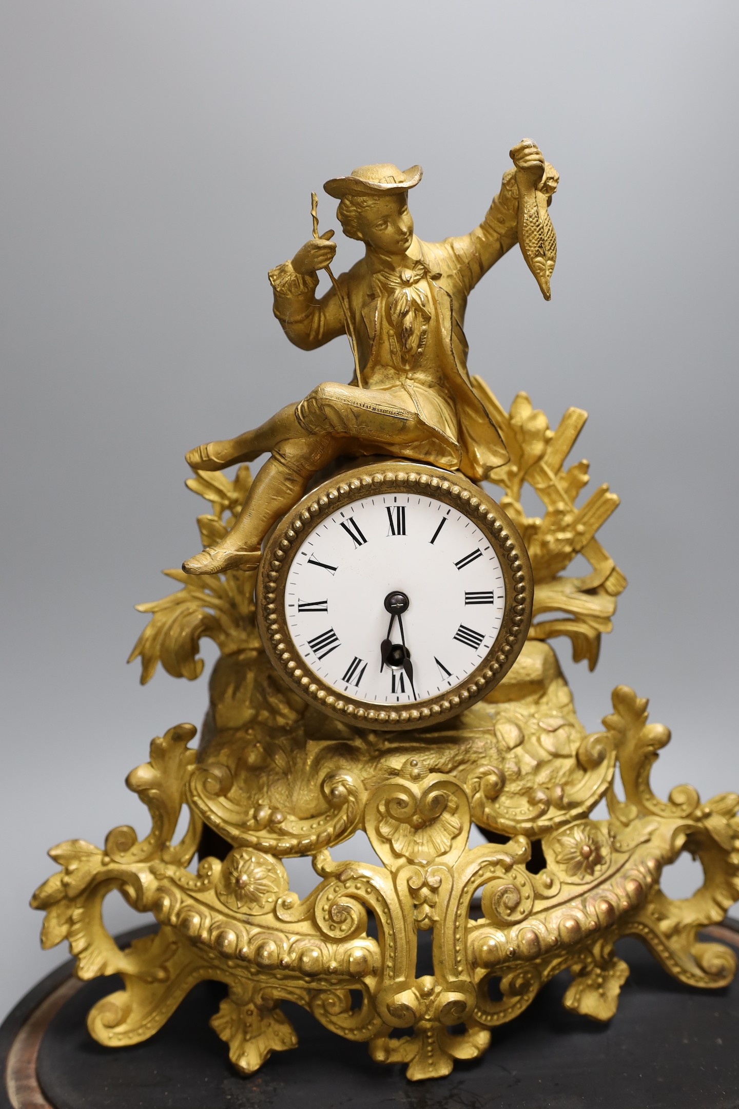 A Victorian gilt spelter mantel clock, under dome, 40 cms high